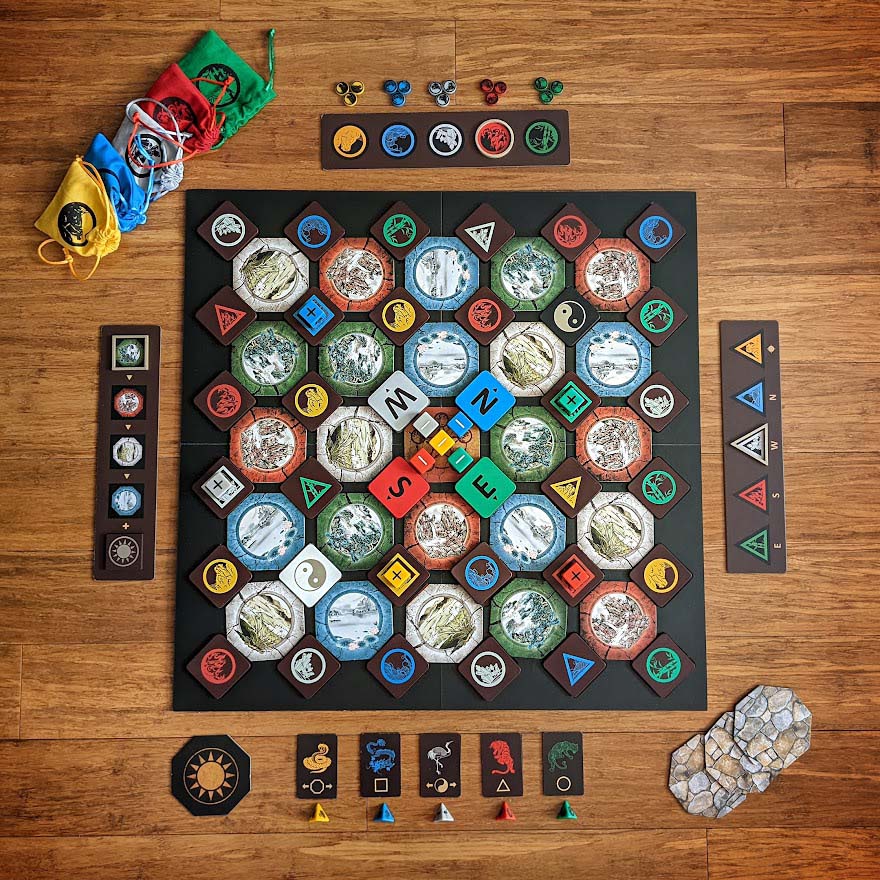 The physical First Edition board and its wooden pieces on a wooden table