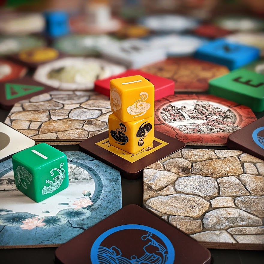 Stacked yellow player pieces on the physical Wu Wei board